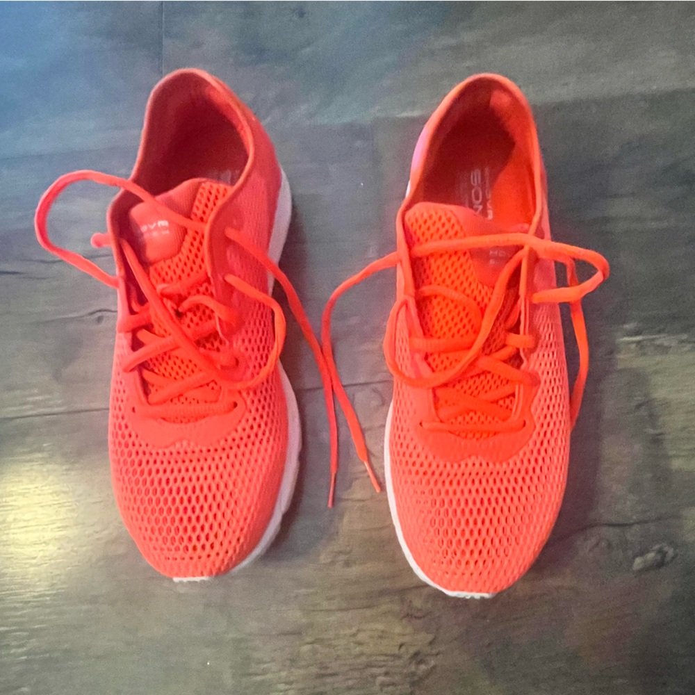 Bright Orange UA tennis shoes.